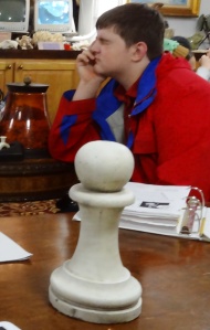 Cole contemplates his next move with the only chess piece left on the table.